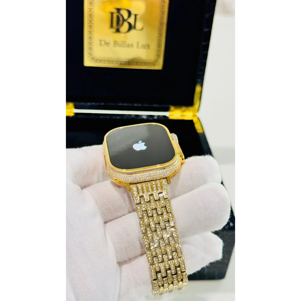 Gold-plated Apple Watch Ultra with inlaid zircon case accents and a rhinestone link band; customization design reference.