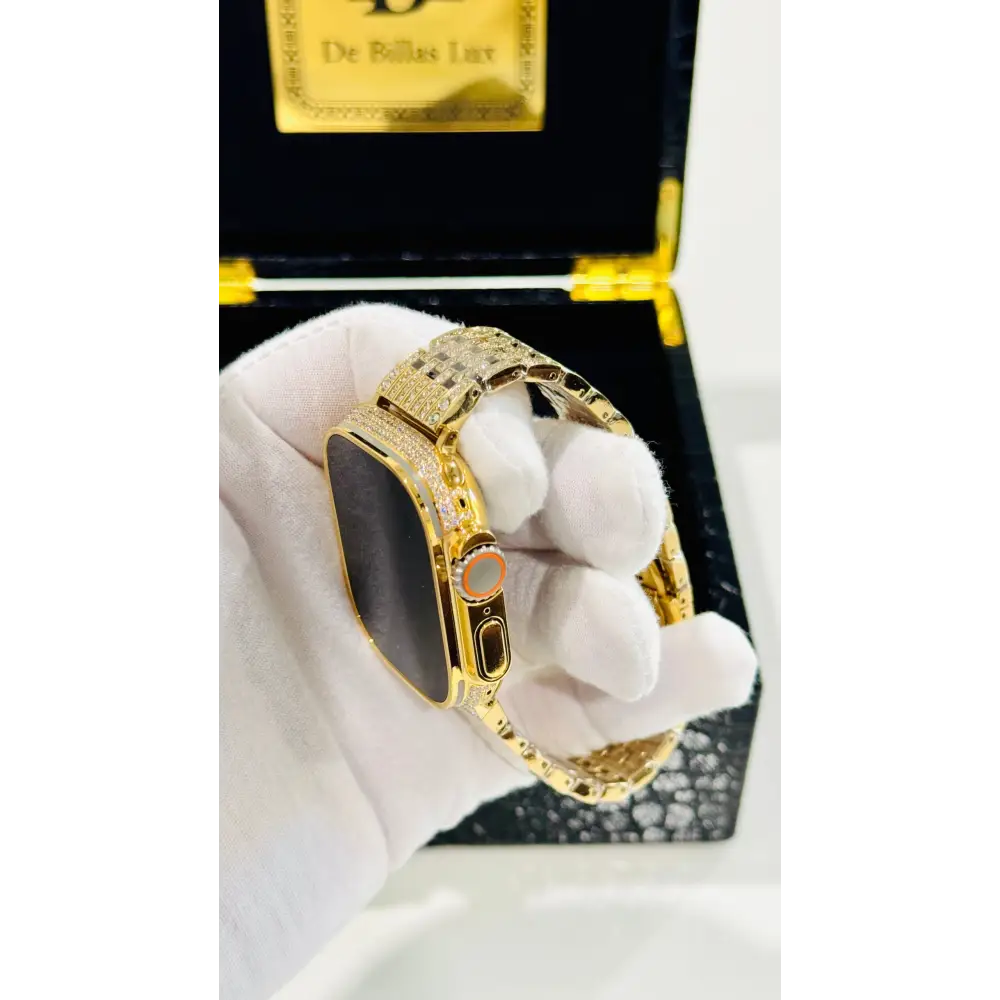 Gold-plated Apple Watch Ultra with inlaid zircon case accents and a rhinestone link band; customization design reference.