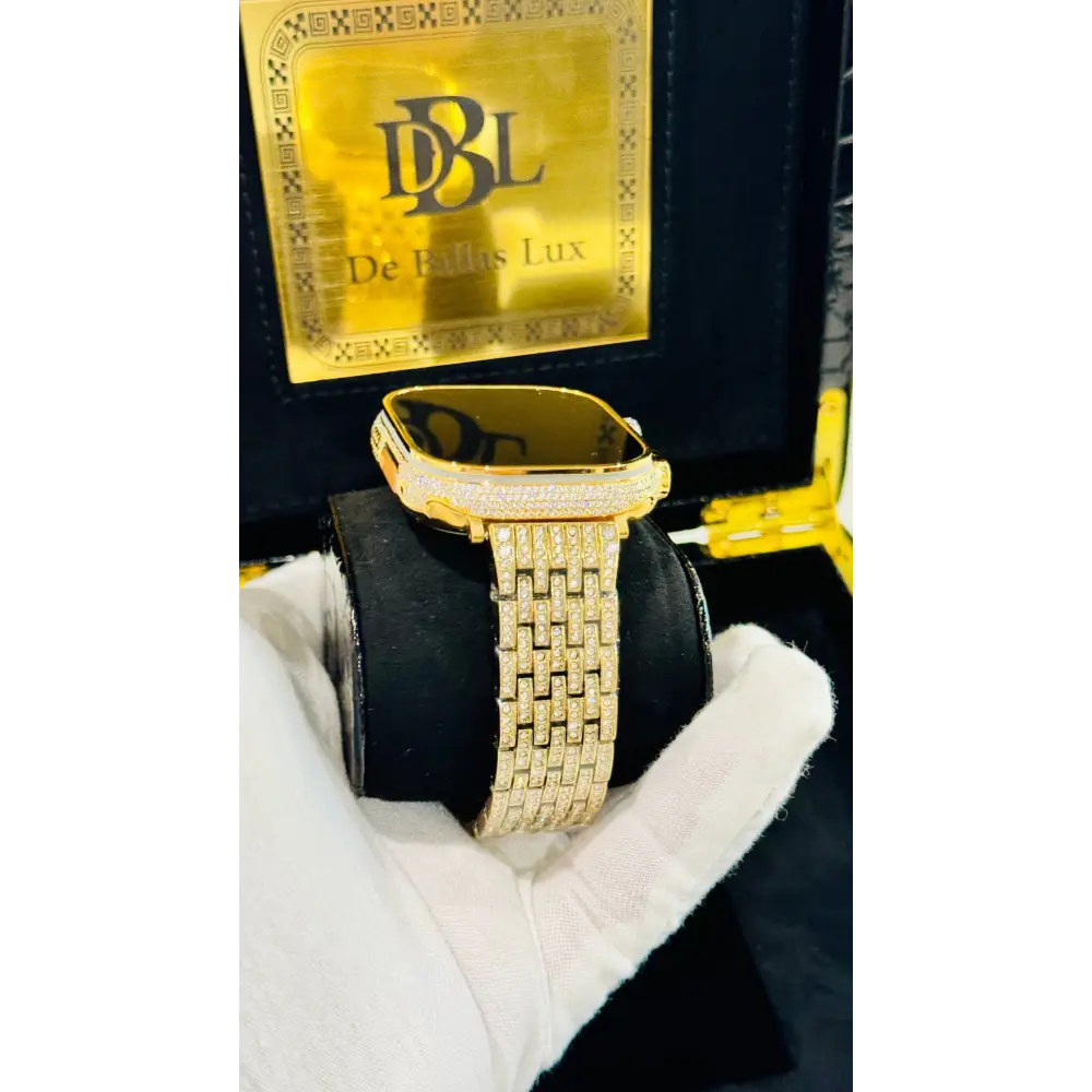 Gold-plated Apple Watch Ultra with inlaid zircon case accents and a rhinestone link band; customization design reference.