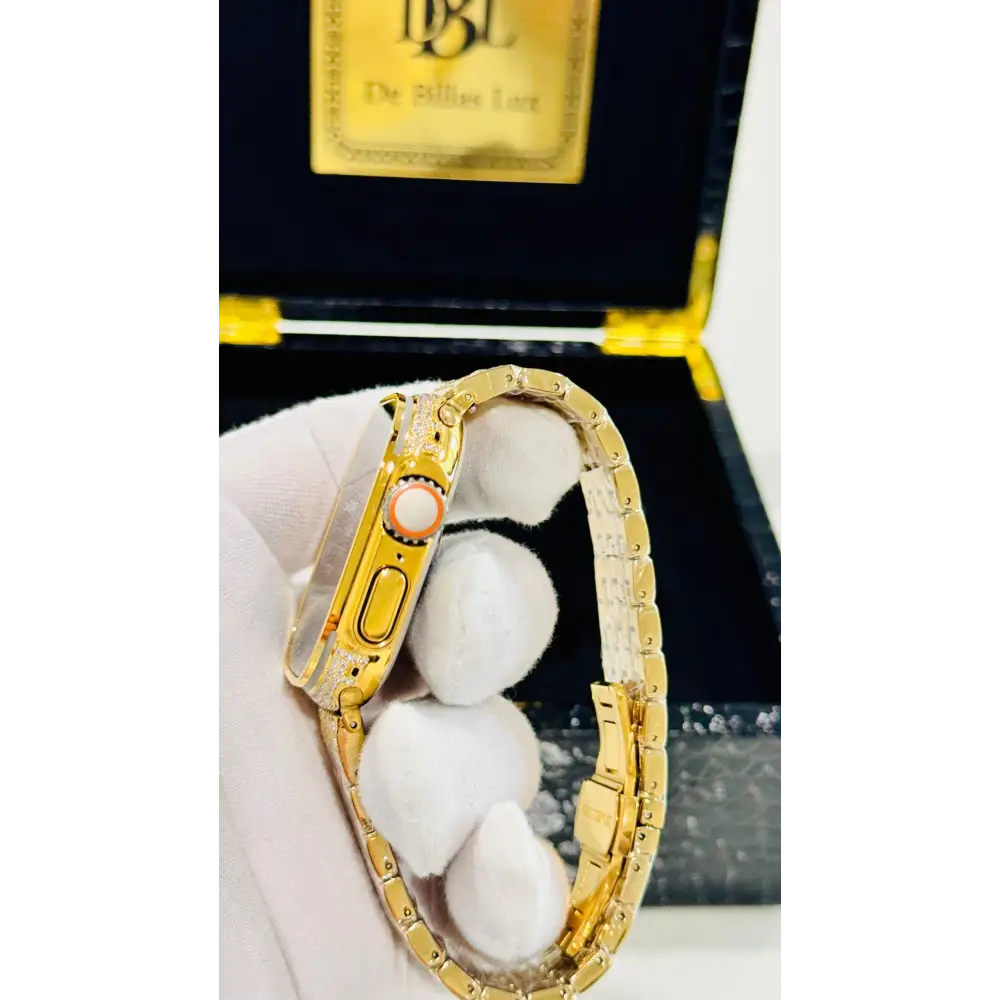 Gold-plated Apple Watch Ultra with inlaid zircon case accents and a rhinestone link band; customization design reference.