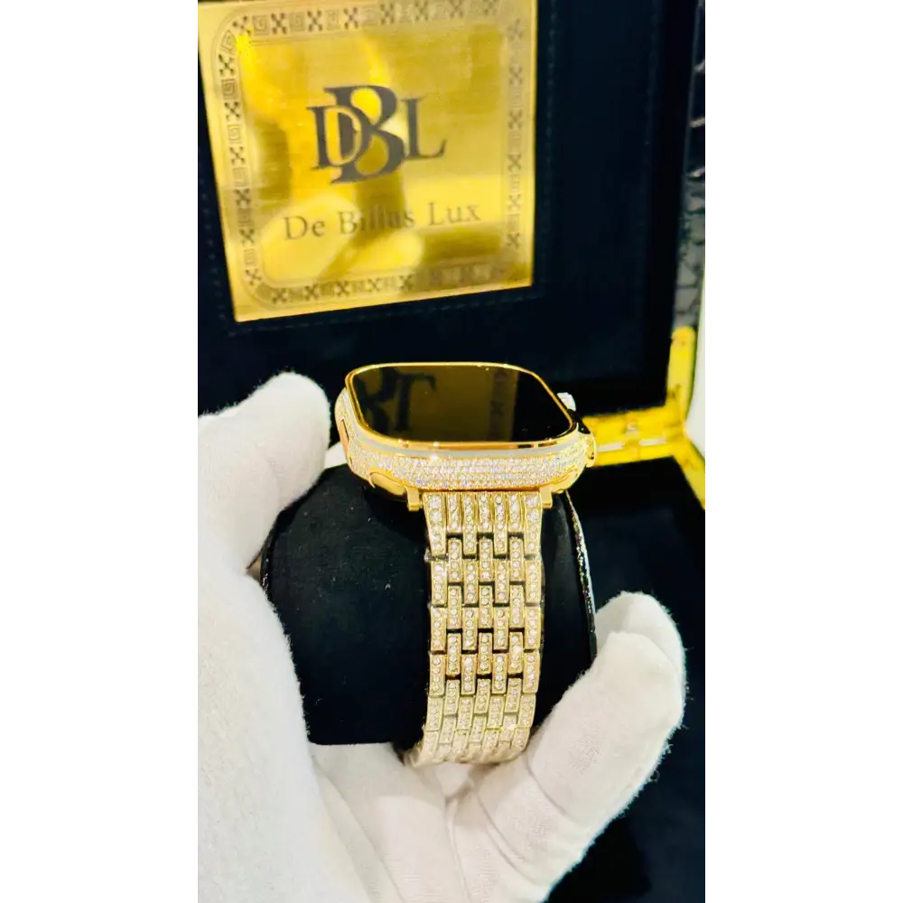 Gold-plated Apple Watch Ultra with inlaid zircon case accents and a rhinestone link band; customization design reference.