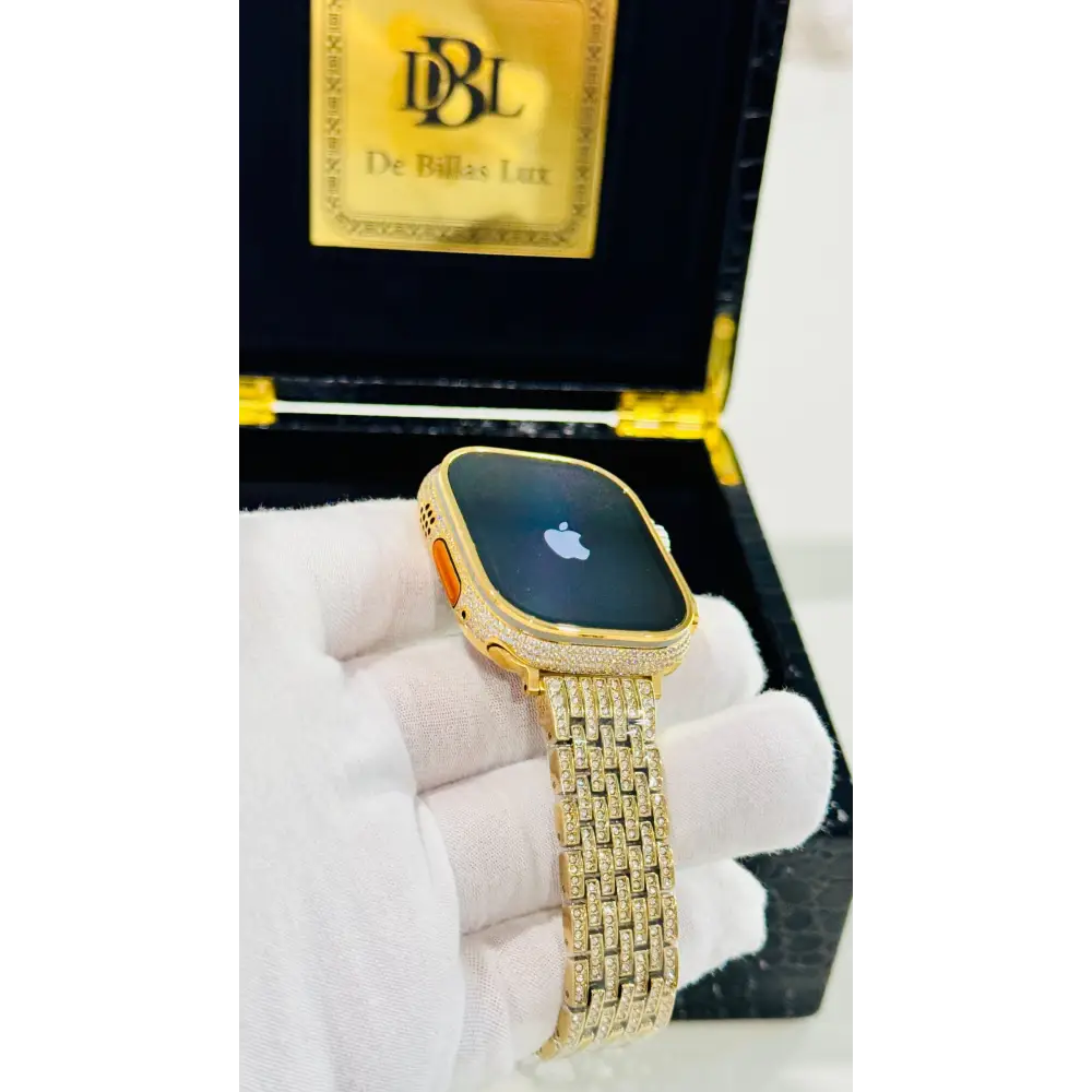 Gold-plated Apple Watch Ultra with inlaid zircon case accents and a rhinestone link band; customization design reference.