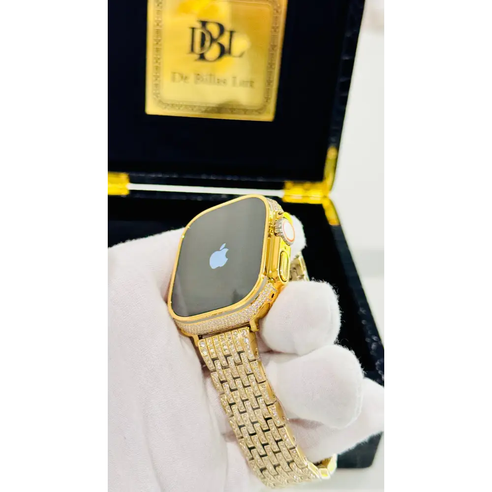 Gold-plated Apple Watch Ultra with inlaid zircon case accents and a rhinestone link band; customization design reference.