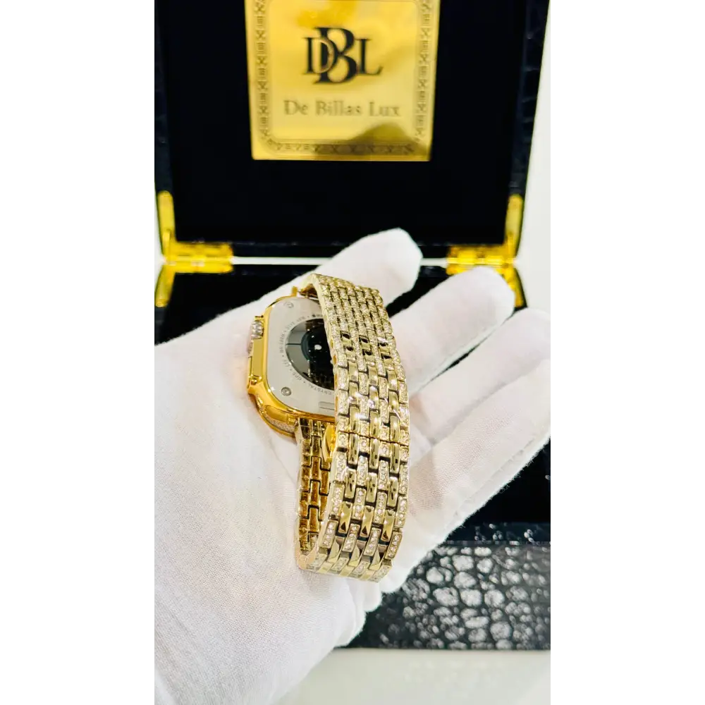 Gold-plated Apple Watch Ultra with inlaid zircon case accents and a rhinestone link band; customization design reference.