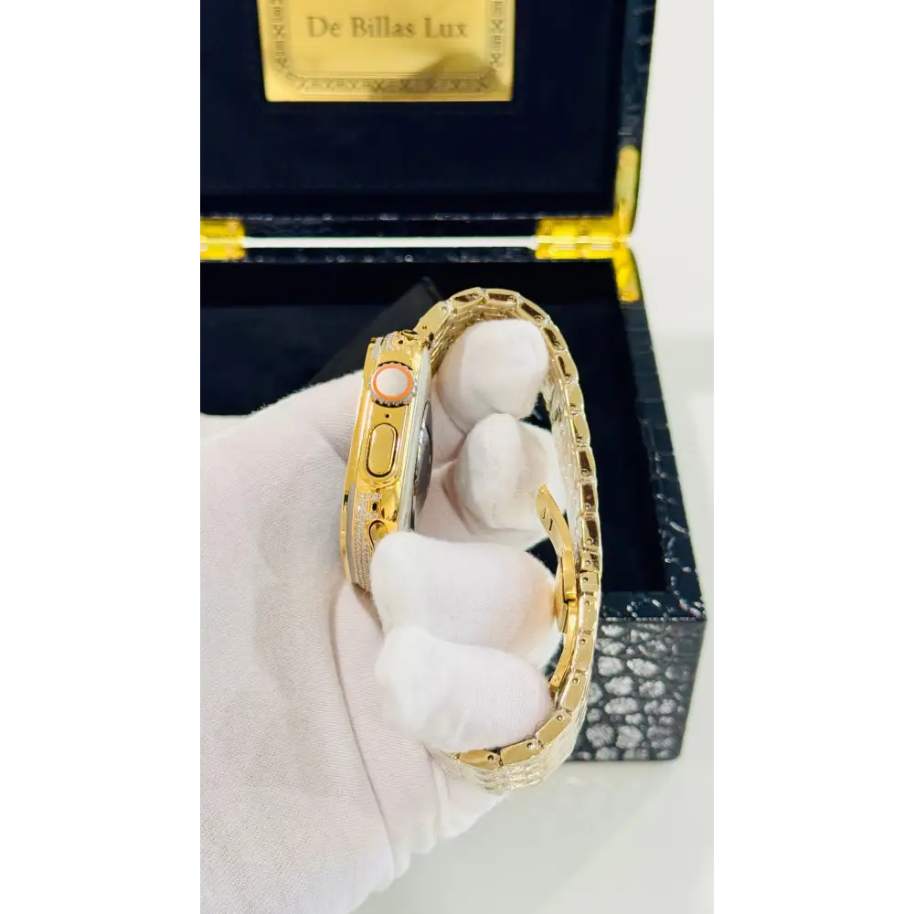Gold-plated Apple Watch Ultra with inlaid zircon case accents and a rhinestone link band; customization design reference.