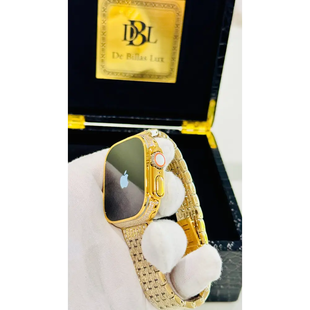 Gold-plated Apple Watch Ultra with inlaid zircon case accents and a rhinestone link band; customization design reference.