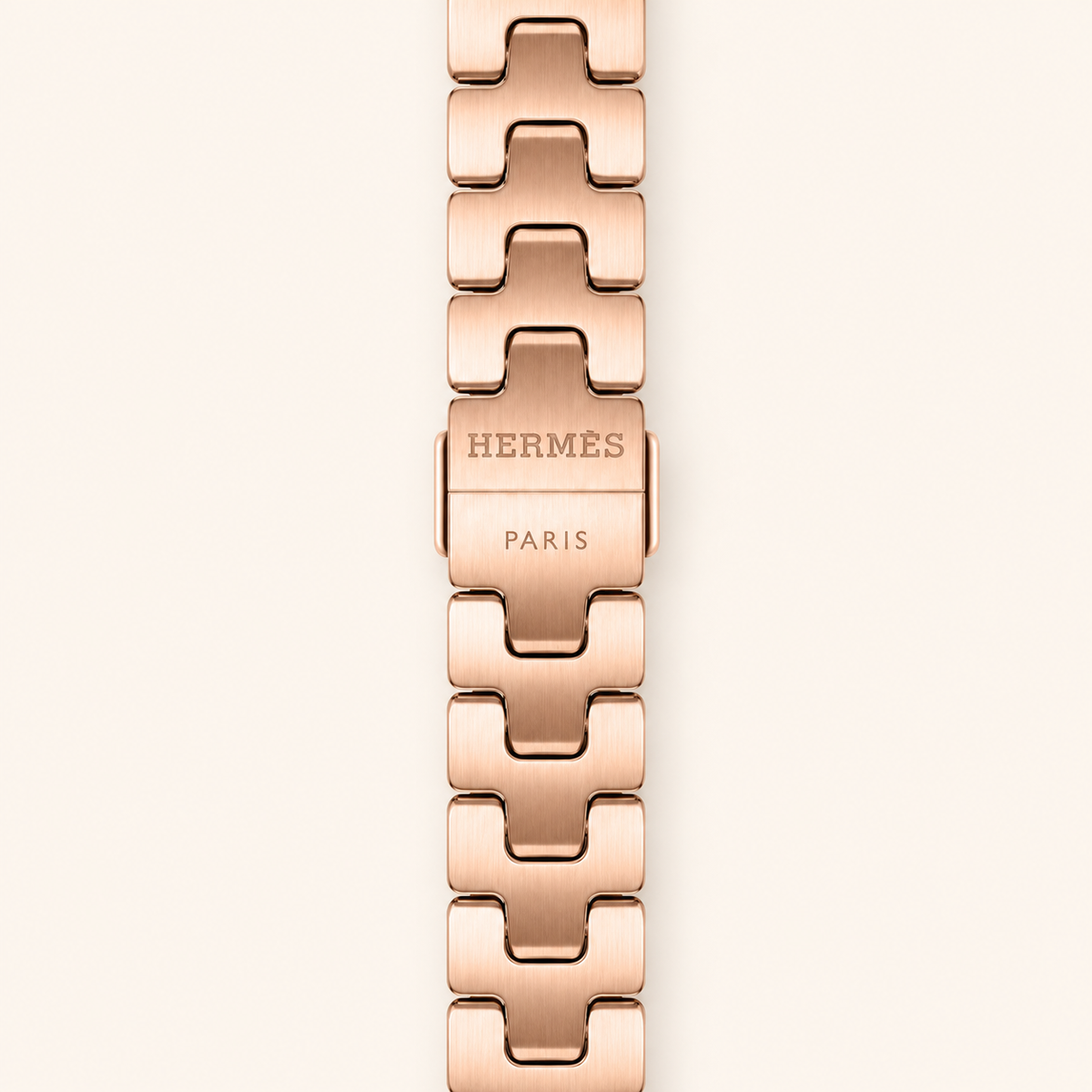 Close-up of rose-gold Hermès Grand H Fin band clasp with Hermès Paris engraving