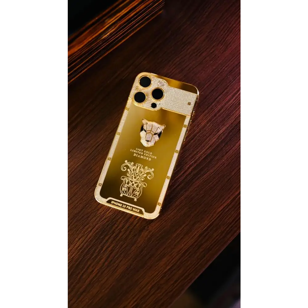 Gold-finish panther-design phone on a dark wooden surface