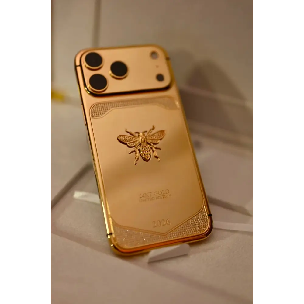 Gold-finish phone with bee emblem, angled rear view