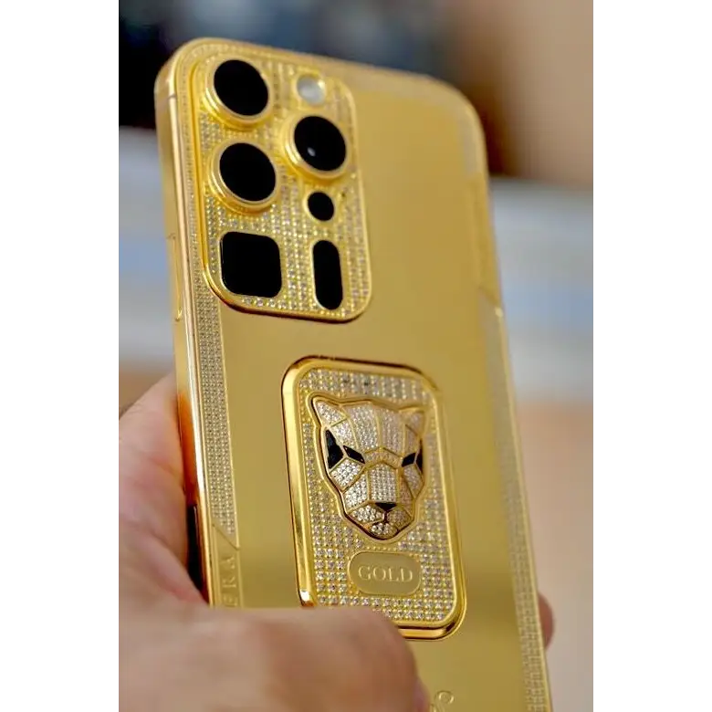Angled rear view of a gold-finish phone with a panther emblem and rhinestone decoration