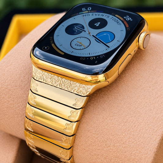 Custom 24K gold Apple Watch Series 9 with display on and engraved gold link band