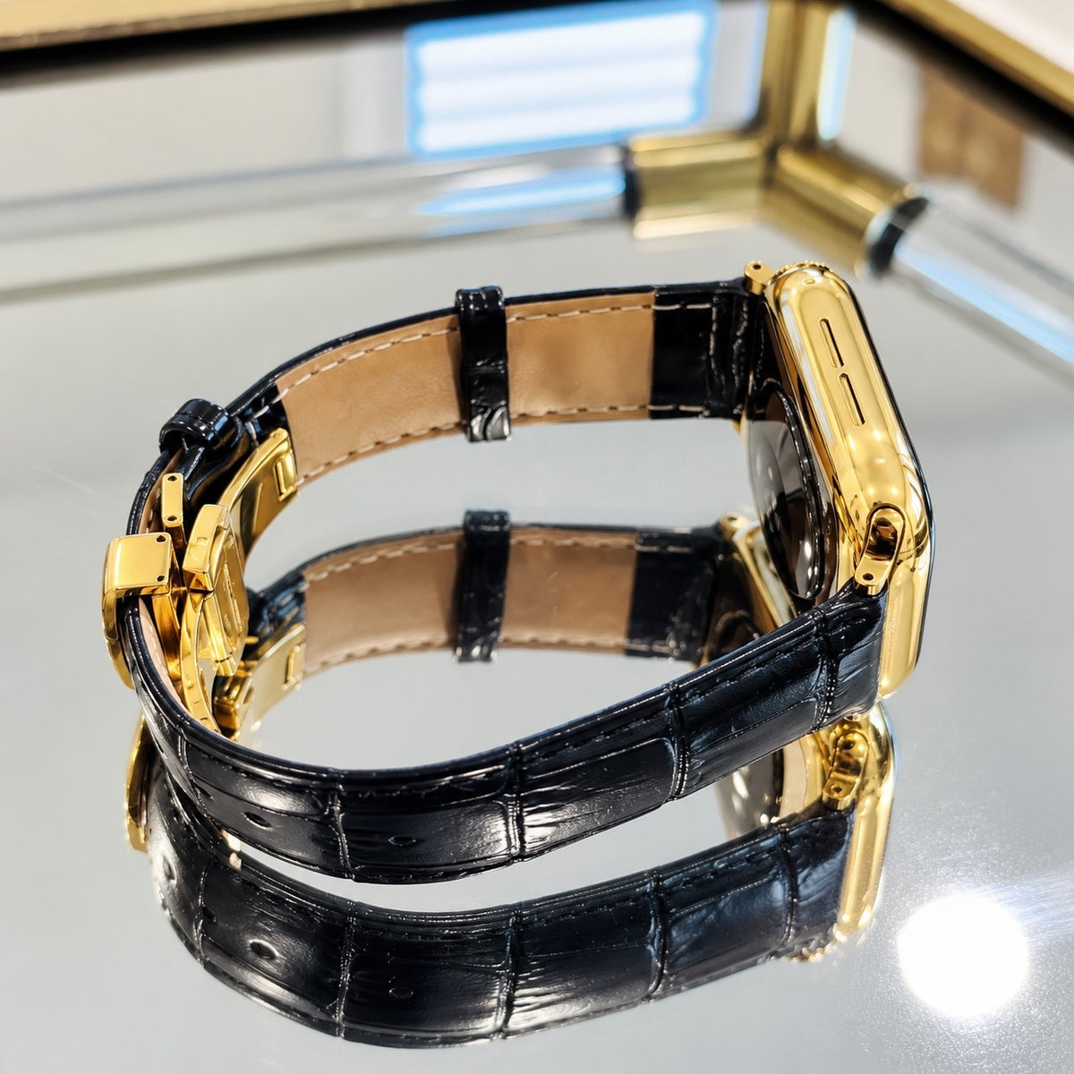 Side view of custom 18K gold Apple Watch Series 12 aluminum case and black alligator leather band