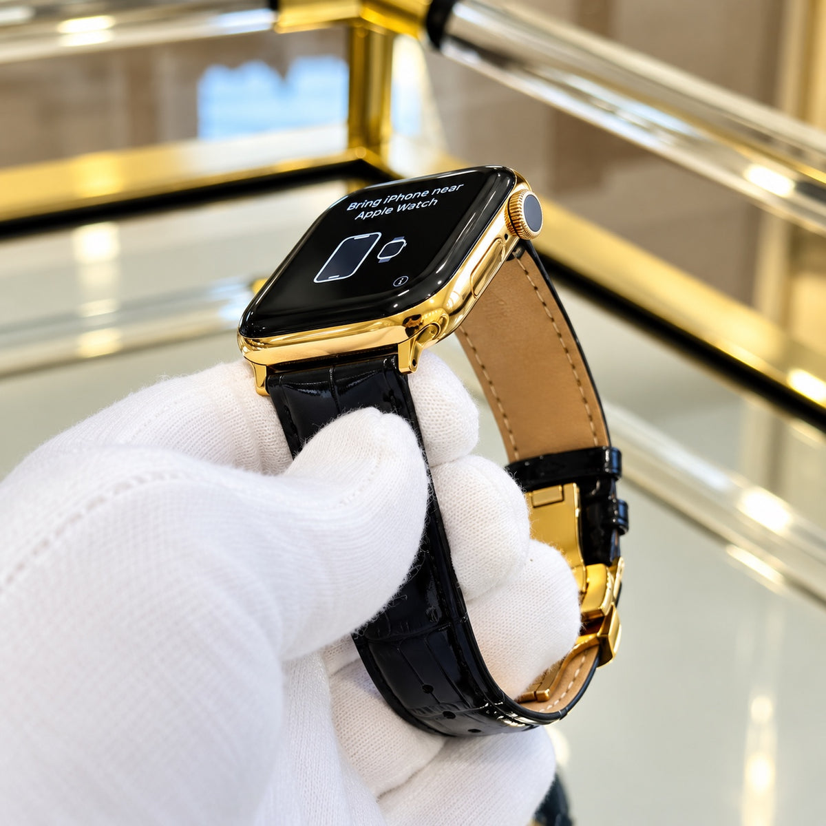 Full view of custom 18K gold Apple Watch Series 12 and black alligator leather band with deployant buckle