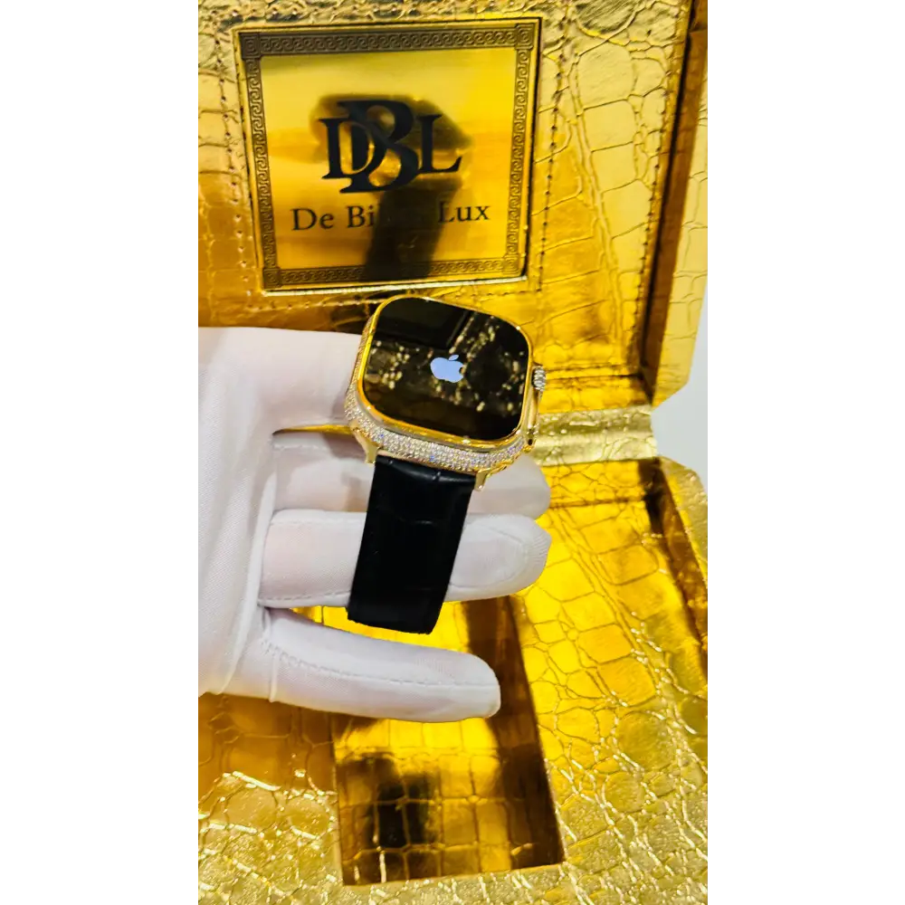 Gold-plated Apple Watch Ultra with inlaid zircon case accents and a black leather band; customization design reference.