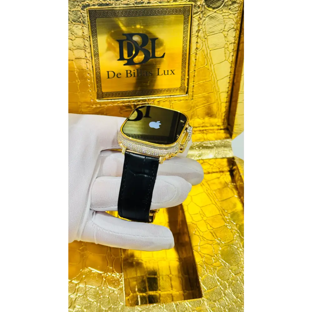 Gold-plated Apple Watch Ultra with inlaid zircon case accents and a black leather band; customization design reference.
