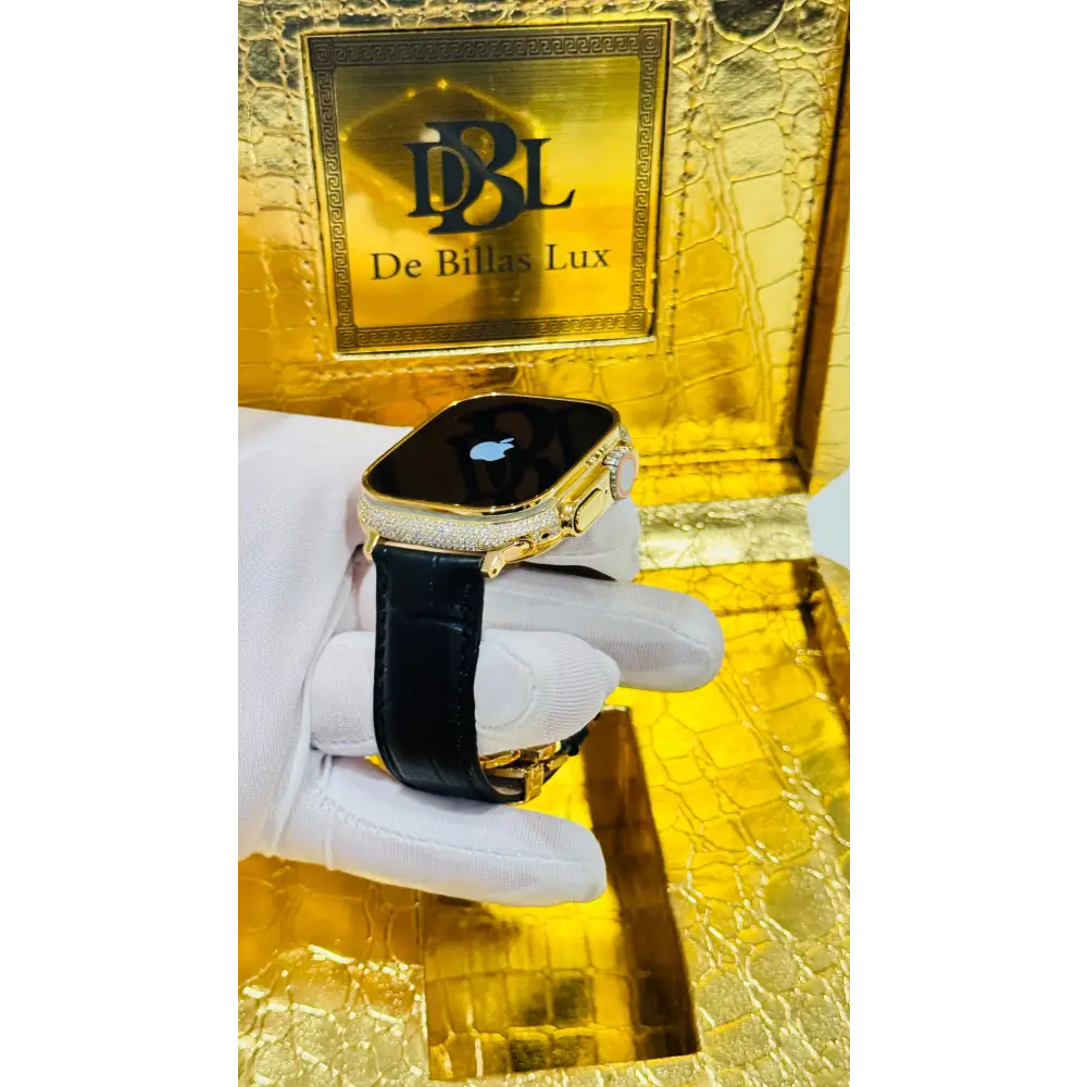 Gold-plated Apple Watch Ultra with inlaid zircon case accents and a black leather band; customization design reference.