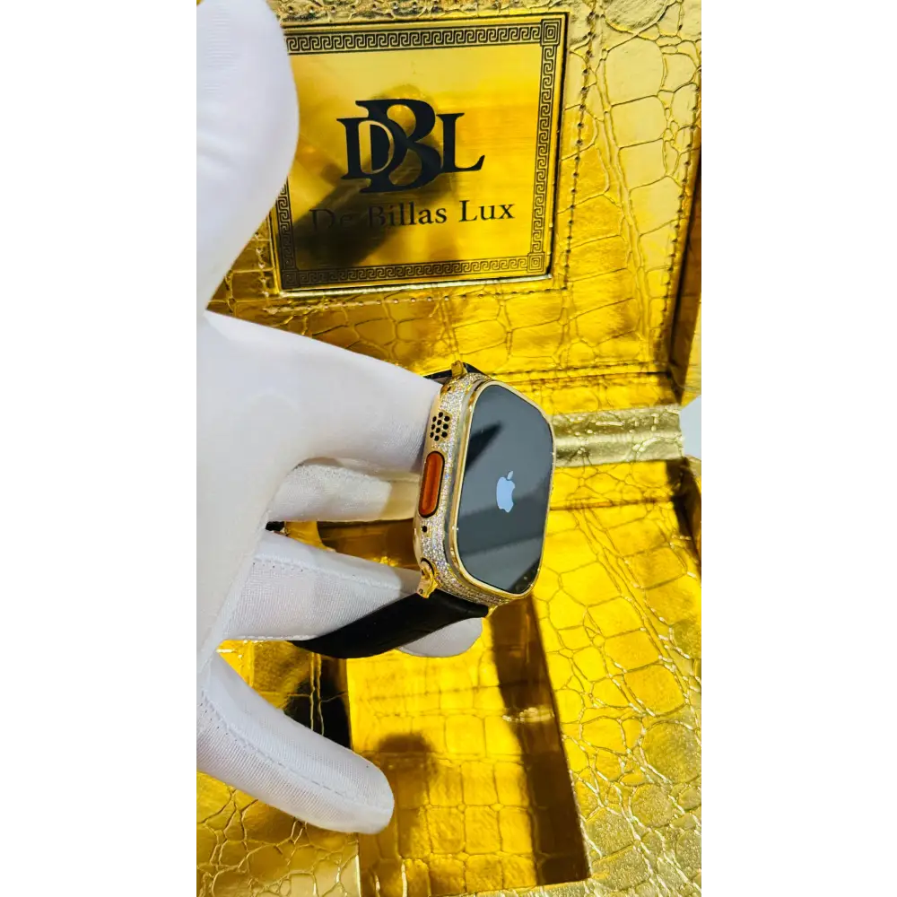 Gold-plated Apple Watch Ultra with inlaid zircon case accents and a black leather band; customization design reference.
