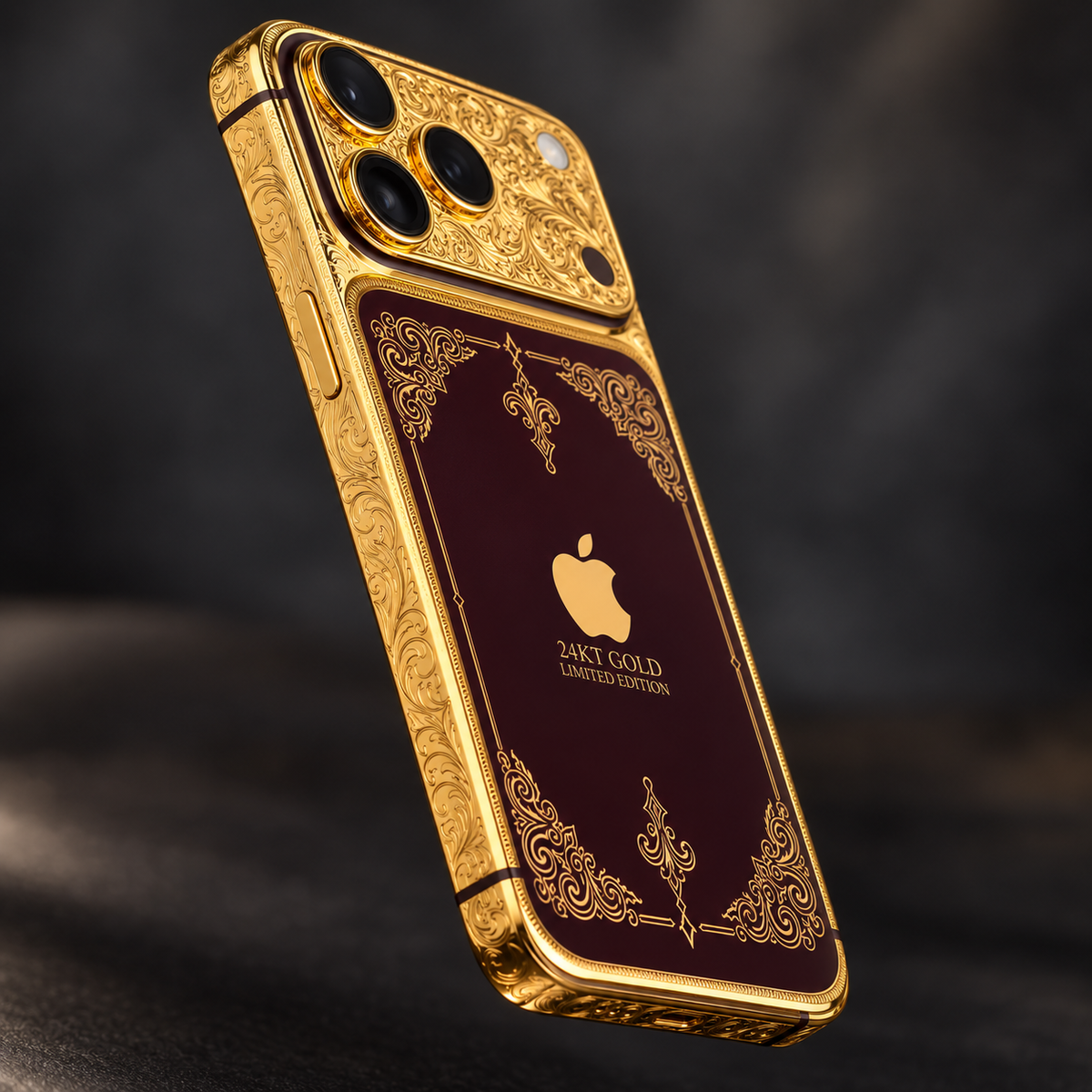 Custom iPhone 18 Pro Max in 24K gold and burgundy, angled view showing the engraved gold rail and burgundy accents