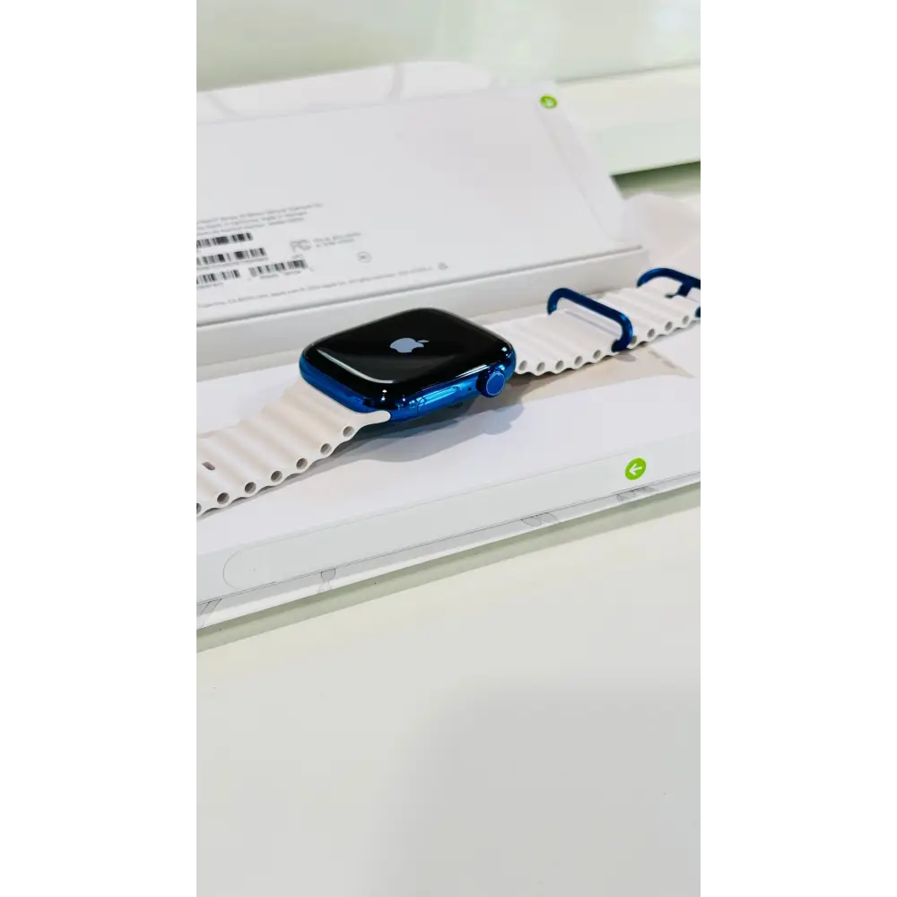 Polished blue Apple Watch with a white band; finish reference. The listing identifies the included band, case size and selected generation.