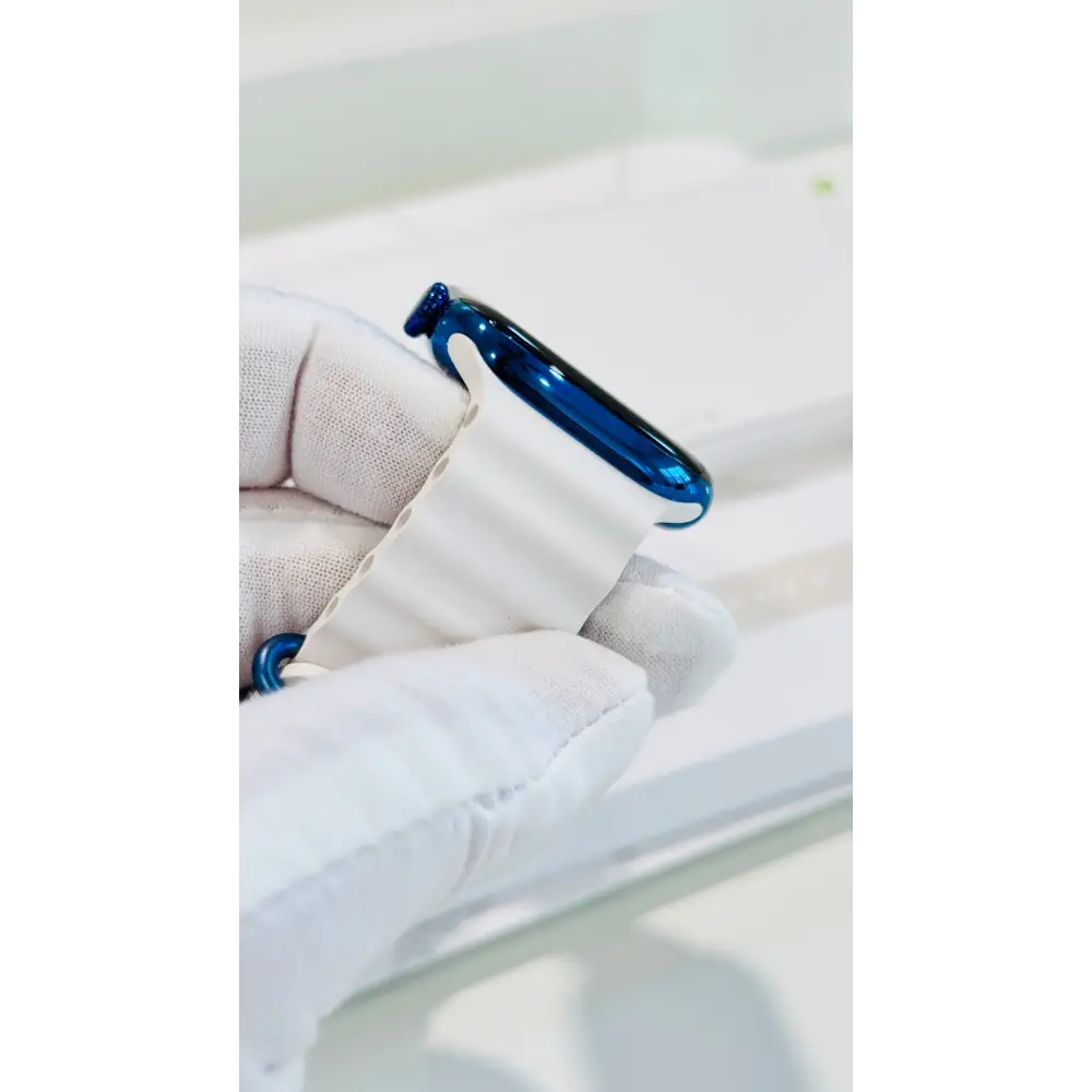 Polished blue Apple Watch with a white band; finish reference. The listing identifies the included band, case size and selected generation.