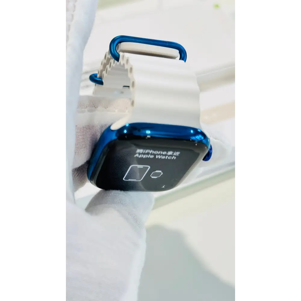 Polished blue Apple Watch with a white band; finish reference. The listing identifies the included band, case size and selected generation.