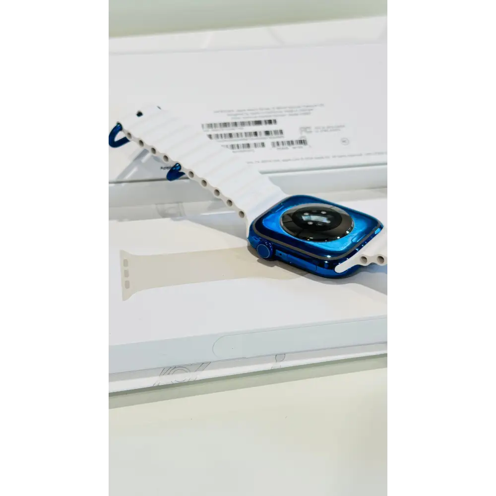 Polished blue Apple Watch with a white band; finish reference. The listing identifies the included band, case size and selected generation.