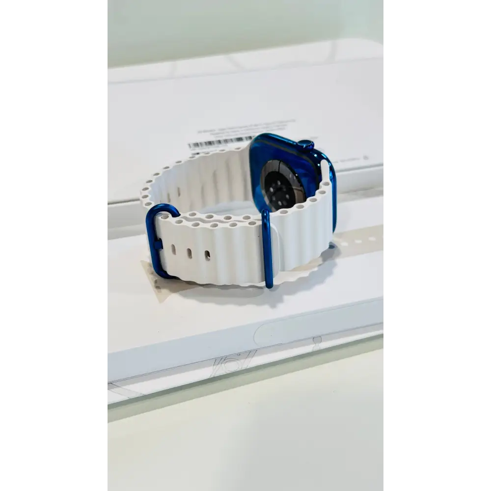 Polished blue Apple Watch with a white band; finish reference. The listing identifies the included band, case size and selected generation.