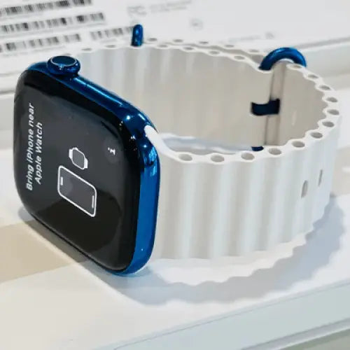 Polished blue Apple Watch with a white band; finish reference. The listing identifies the included band, case size and selected generation.