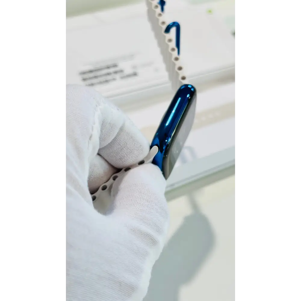 Polished blue Apple Watch with a white band; finish reference. The listing identifies the included band, case size and selected generation.