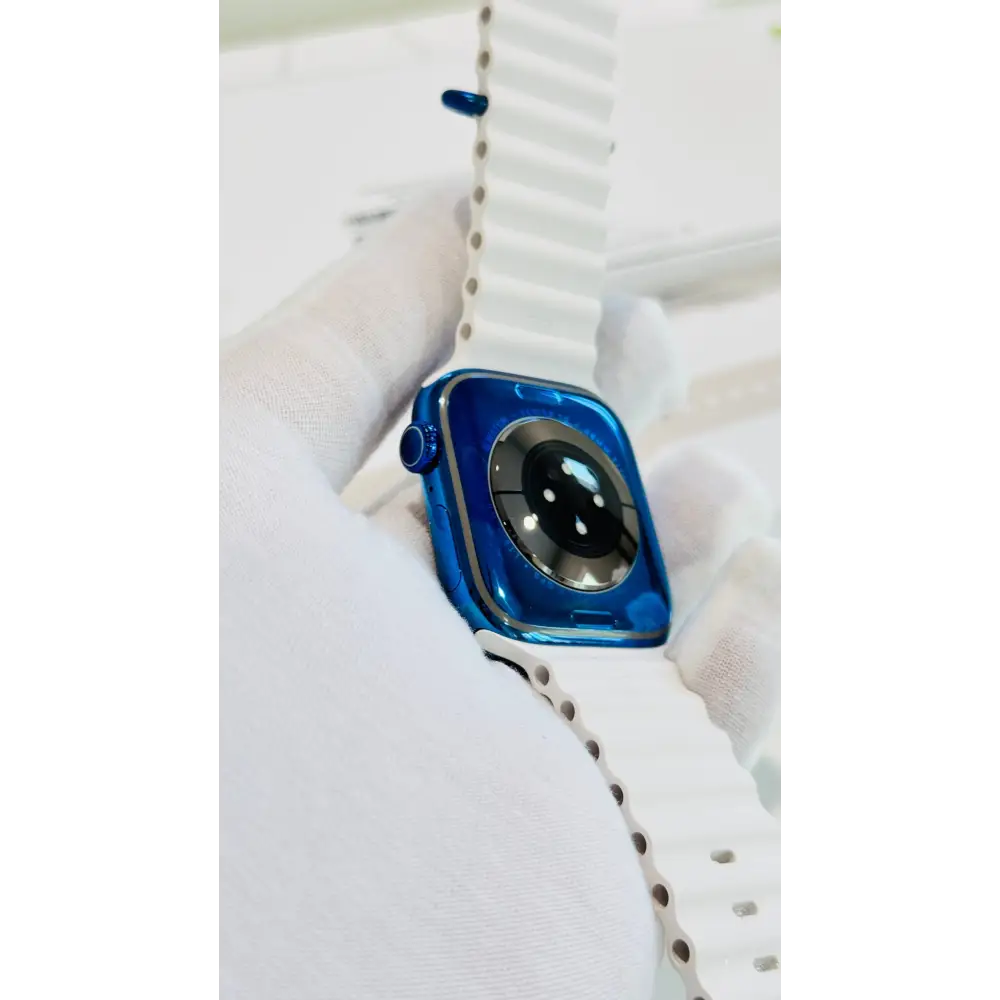 Polished blue Apple Watch with a white band; finish reference. The listing identifies the included band, case size and selected generation.