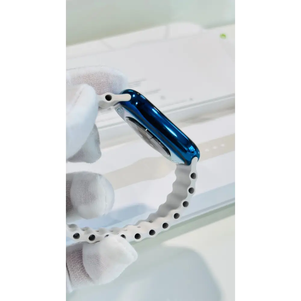 Polished blue Apple Watch with a white band; finish reference. The listing identifies the included band, case size and selected generation.