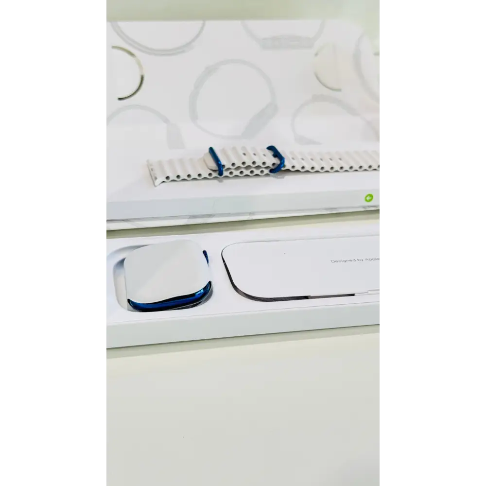 Polished blue Apple Watch with a white band; finish reference. The listing identifies the included band, case size and selected generation.