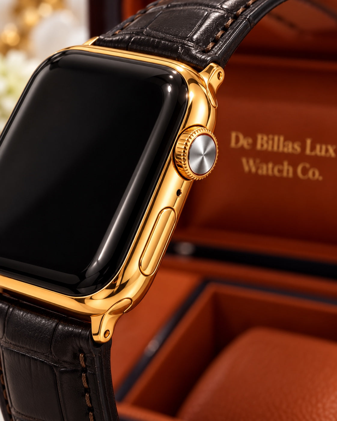 Close-up of the gold-plated Apple Watch Series 9 case, silver Digital Crown face and black leather band