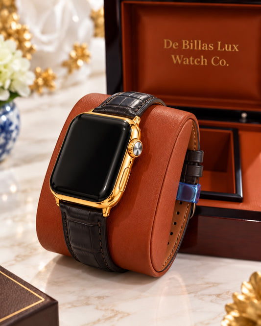 Gold-plated Apple Watch Series 9 with black leather strap and tan lining wrapped around a brown cushion