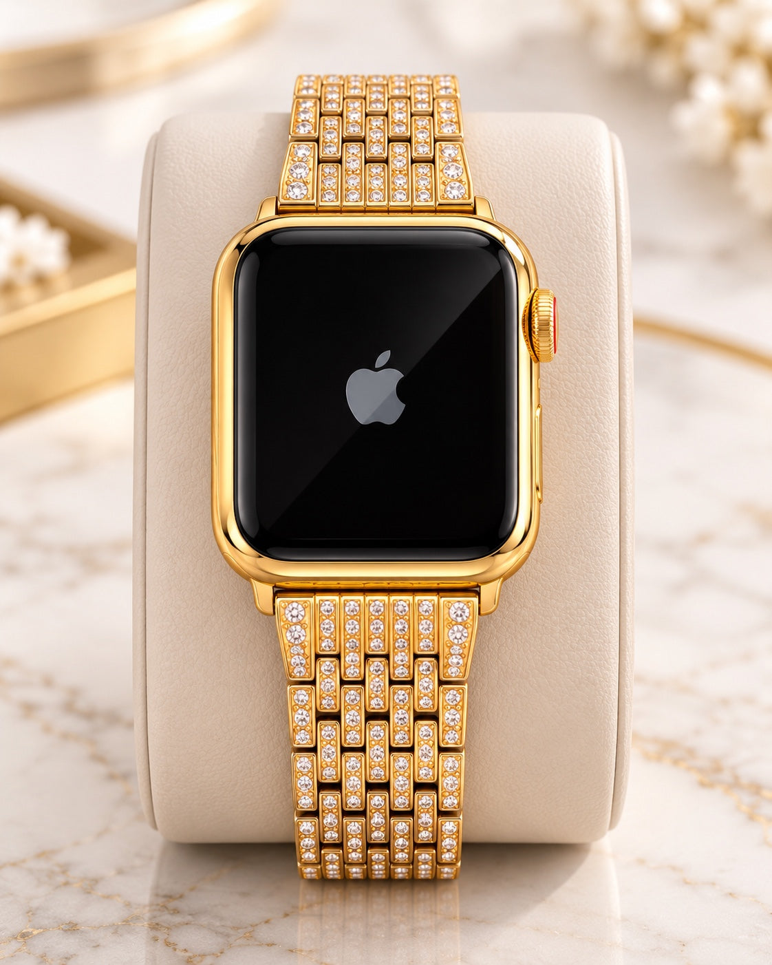 Custom 24K gold Apple Watch with rhinestone link band, front view on an ivory cushion