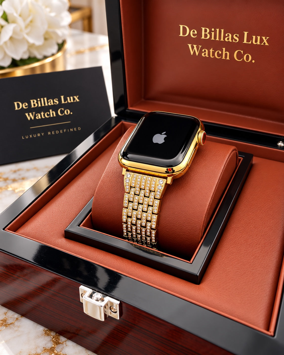 Custom gold Apple Watch with rhinestone band in a brown-lined wooden box beside De Billas Lux branding