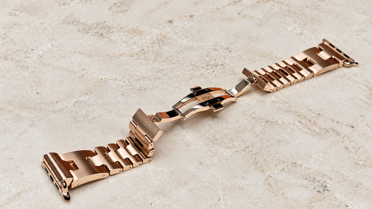 Rose gold plated Hermès Grand H Apple Watch band, diagonal full-band view — generated supplemental view