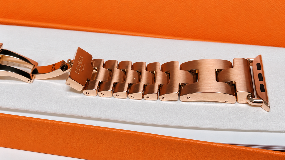 Custom rose gold plated Hermès Grand H links and connector in original orange packaging — generated supplemental detail