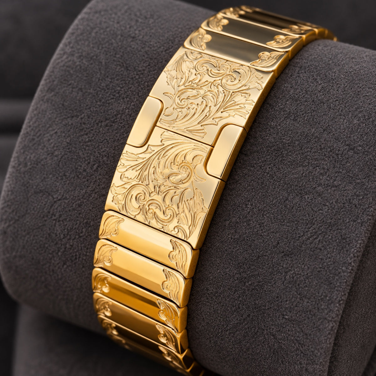 Engraved 24K gold link band clasp on charcoal cushion